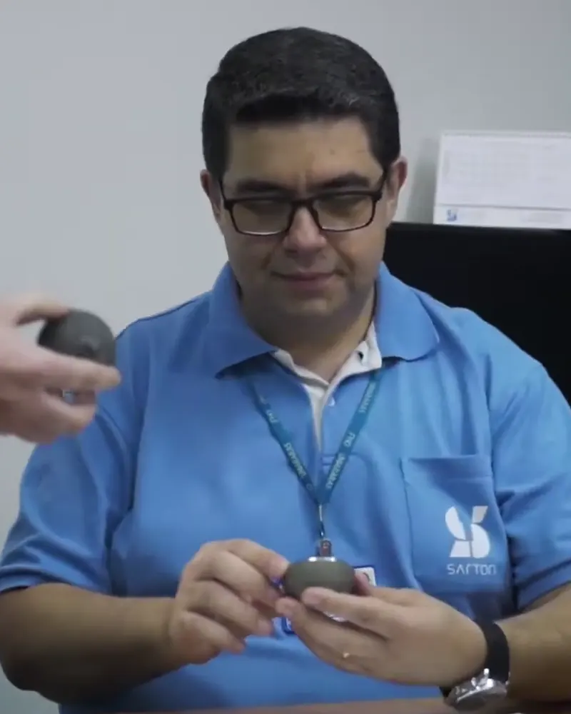 Sartori engineer evaluating a prototype component at the design desk